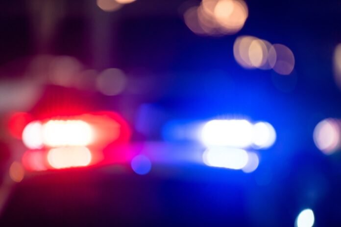 Drunk motorist attempts dangerous maneuver between semi-trucks during late-night incident.